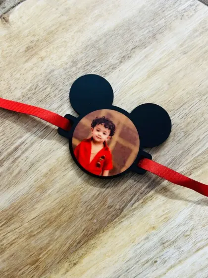 A cute Mickey Mouse-shaped rakhi that can be personalized with a child's photo. Perfect for a little brother.