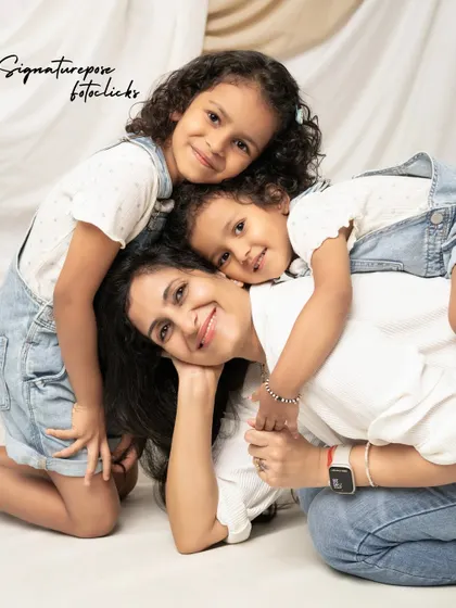 A pile of love! This candid shot of a mother and her two daughters is full of laughter and affection, showcasing the fun and playful side of family portraits.