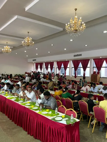 A wide view of guests enjoying our banana leaf lunch at a naming ceremony. We are equipped to serve hundreds of guests simultaneously without compromising on quality or service.