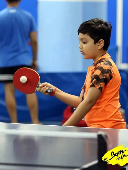 A young player focuses intently on serving the ball. The serve is the only shot you have complete control over, and we spend time perfecting different types of serves.