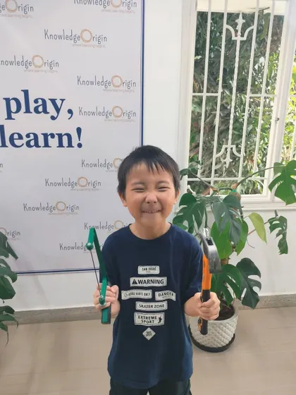 The pure joy of learning a new skill is written all over this camper's face. He is excited to use his tools to bring his ideas to life.