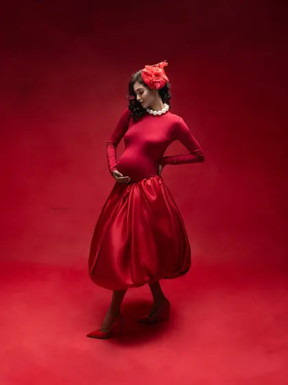 Red on red captures the fierce power within a woman's soul. This look reflects the strength of a mother and the boundless love she has for her baby.