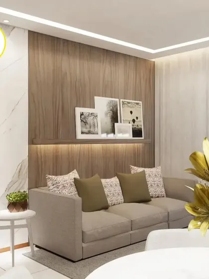 A living room design that combines wood and marble textures. The backlit floating shelf above the sofa is a stylish and functional feature.