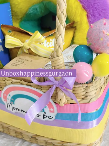 A detailed view of the woven basket and ribbon details on the rainbow-themed hamper. The mini balloon accents add a playful touch to the overall design.