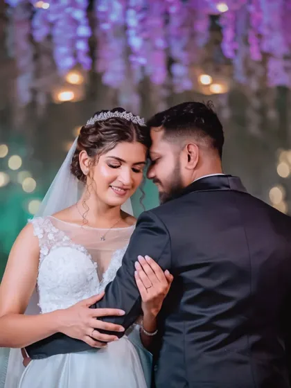 A close, intimate dance at the reception. The soft lighting and her happy expression make this a truly romantic photo.