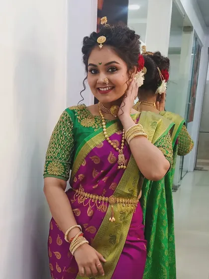 A lovely portrait of a model in a traditional Maharashtrian look for a Gudi Padwa special. The vibrant green and purple saree is paired with a soft, glowing makeup look.