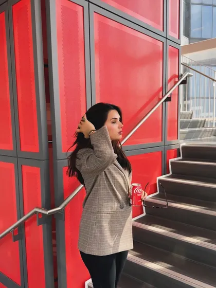 A candid moment, fixing my hair, in my chic and simple college outfit.