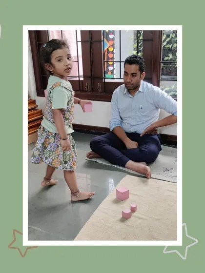 A father watches as his daughter, Saanvi, works with the pink tower. These quiet moments of observation are invaluable for parents to see their child's developing abilities.