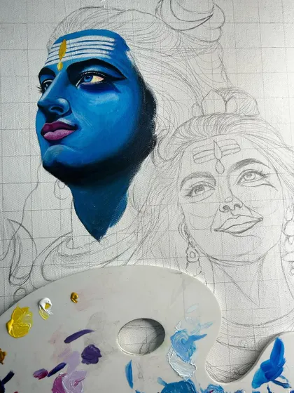 An early stage of the Shiv Parvati painting, with the initial layers of blue being applied to Lord Shiva's face over the pencil grid.