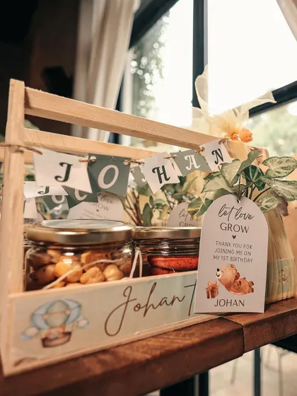 We design party favors that match your theme perfectly, like these custom wooden caddies for a teddy bear party with a "let love grow" tag.