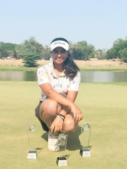 Rashi Mishra poses with her multiple trophies on the green at Kalhaar Greens, Ahmedabad. She secured first place in both Category B and the Combined A & B categories.