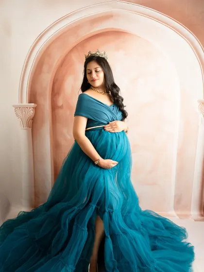 A royal-themed portrait in a beautiful teal gown. The crown and serene expression create a look of pure elegance and grace.