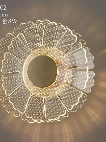 A flower-shaped wall or ceiling light with a beautiful acrylic design that scatters light in a decorative pattern.