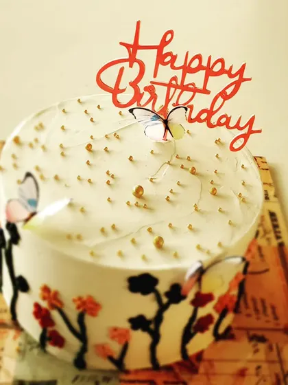 This hand-painted butterfly and floral cake was made for a special mom's birthday. It's a rich chocolate cake with dark chocolate ganache, decorated with edible paint and delicate butterfly toppers.