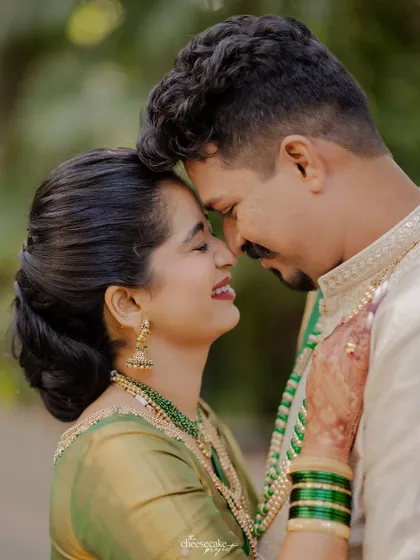A sweet, nose-to-nose moment between the couple, full of smiles.