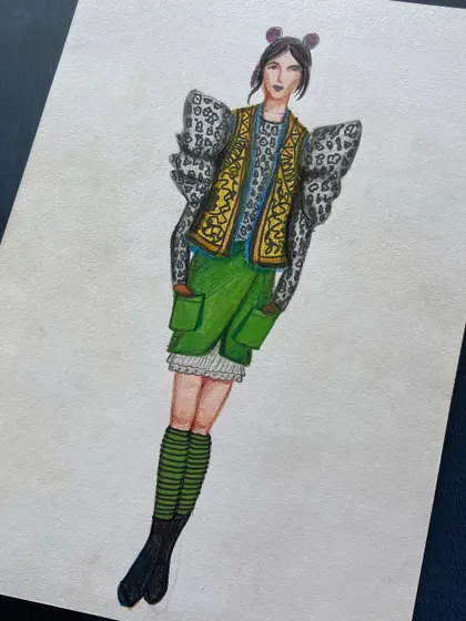 An eclectic design mixing patterns and textures, with exaggerated puff sleeves and a utility skirt.