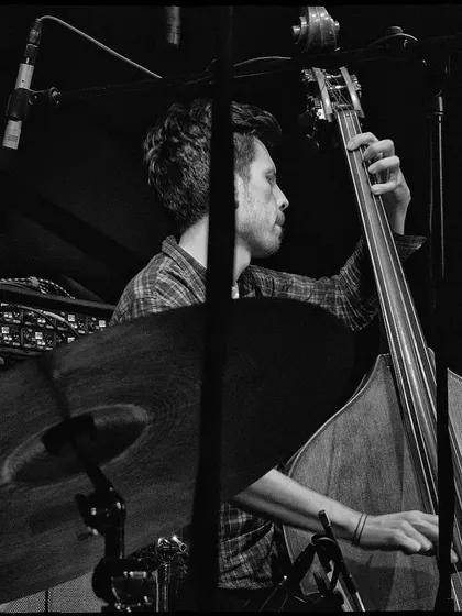 A black and white shot of our bassist at the Nublu concert. The focus is entirely on him and his instrument, highlighting his incredible skill.