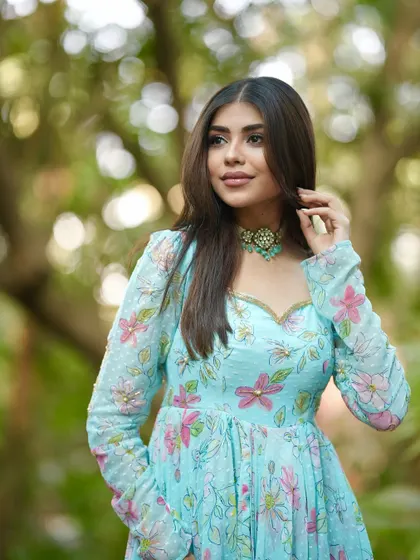 A close-up of the sky-blue floral Anarkali, showing the sweetheart neckline and the delicate print.