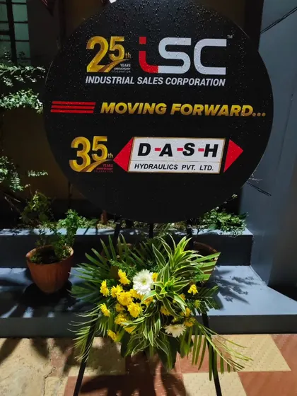 A custom branded sign I created for the Industrial Sales Corporation's 25th anniversary. The sign is complemented by a fresh floral arrangement at its base.
