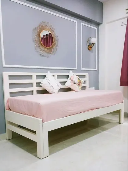 This versatile piece functions as a stylish diwan or daybed and can be expanded to a full-size bed when needed. Its clean, white frame and minimalistic design make it a perfect fit for modern, multi-functional living spaces.