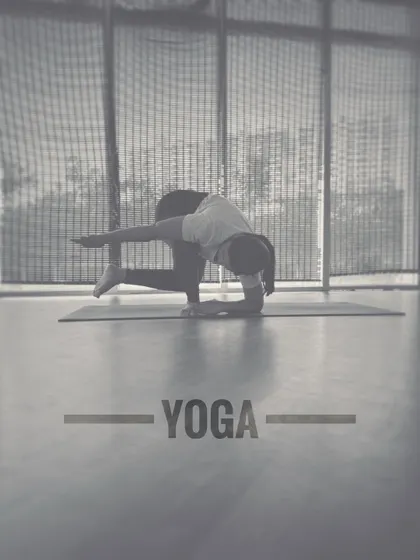 A black and white shot of the same arm balance, emphasizing the form and stillness of the pose.