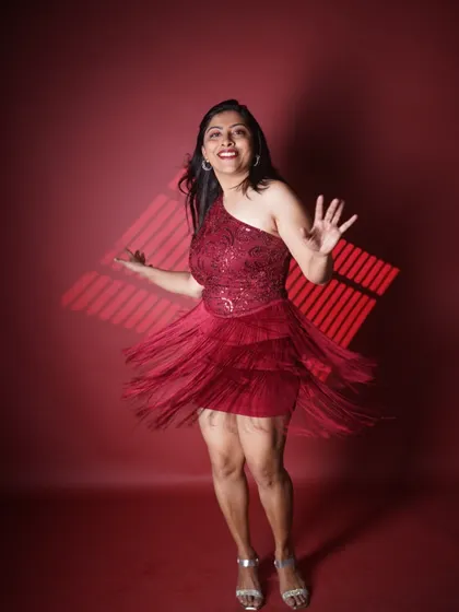 A duplicate of another image, this captures the joyful, twirling motion of the red fringe dress, reflecting the high energy I bring to the dance floor.