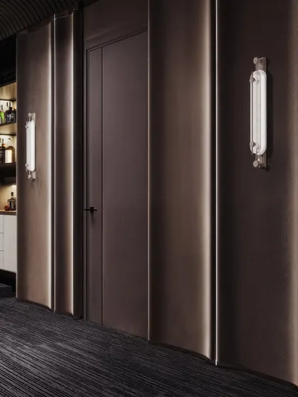 A detail shot of the entertainment room's wall treatment, featuring curved, acoustically-friendly panels and elegant wall sconces.