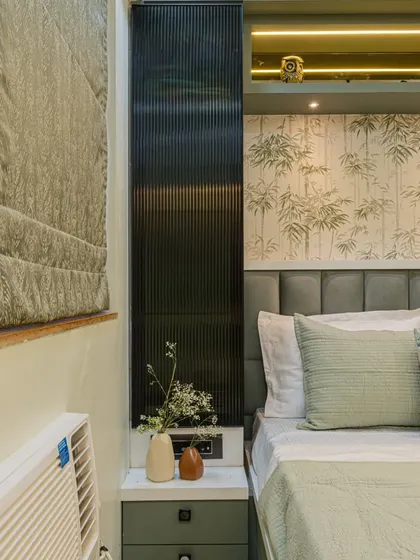 Another angle of this serene bedroom, showing the bedside table integrated with the headboard paneling. This creates a clean, built-in look and saves floor space.