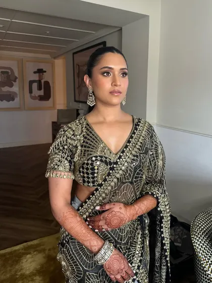 Another view of Shanel's glamorous look. The intricate black and gold saree is the perfect canvas for such a strong and elegant makeup and hair style.
