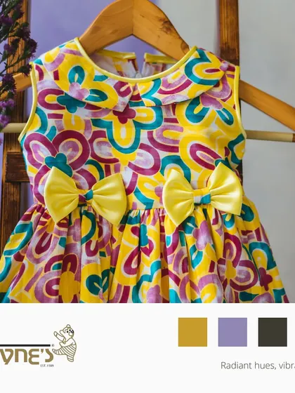 A graphic celebrating radiant hues and vibrant style, featuring a playful and colorful printed dress with two sweet yellow bows.