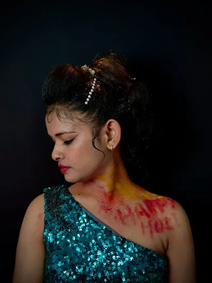 A creative look for a themed shoot, combining a messy, textured updo with body paint and a sequined dress. Our students learn to create a cohesive look from head to toe.