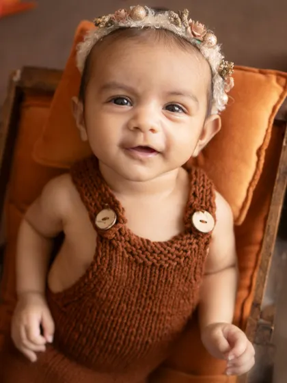 A calm and gentle gaze. This close-up portrait shows the beautiful, soft features of this 3-month-old baby girl.