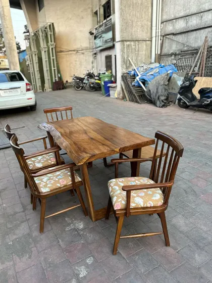 The dining set is shown with four chairs, perfect for a small restaurant or a private dining room.