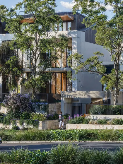Another angle of the contemporary residential complex, showing the tiered landscaping and pedestrian pathways that are integrated into the design.