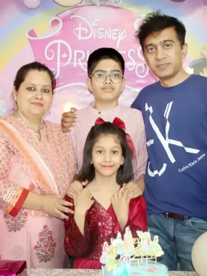 A complete family portrait at a Disney Princess themed birthday, capturing multiple generations celebrating together.