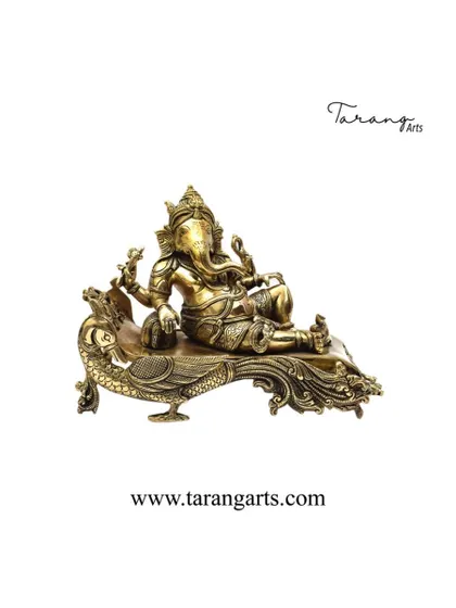 This brass sculpture portrays Lord Ganesha in a relaxed pose, reclining on a peacock. It is a unique and artistic representation that combines the remover of obstacles with the vehicle of his brother, Lord Murugan, symbolizing harmony and divine grace.