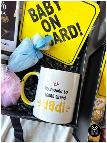 A rainbow-themed pregnancy announcement hamper celebrating a rainbow baby, with a special mug for the 'Great Grand Dadi'.