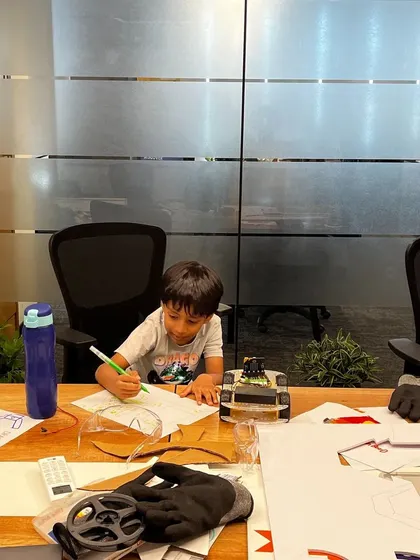 Another young engineer is deep in thought, planning the mechanics of his robot. This photo captures the focus and determination we see in our students every day.