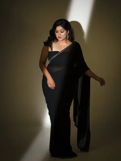 Another view of the black saree look, highlighting its modern and chic appeal.