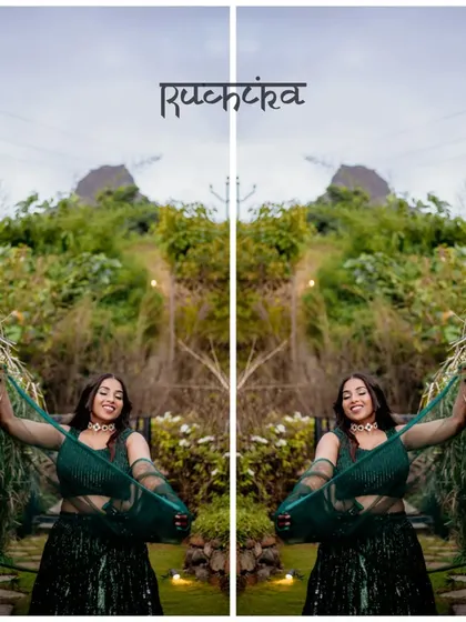 A creative, mirrored portrait of the bride in a lush green setting, highlighting her beautiful green lehenga.