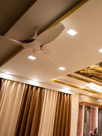 A stylish ceiling fan and automated lighting in a modern bedroom, all controllable via smart panel or voice command.