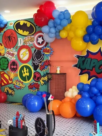 KAPOW! An action packed Avengers and DC superhero theme, using bright primary colors and iconic logos to create a dynamic backdrop for a young hero's party.