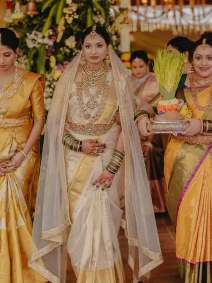 The bride's grand entrance, surrounded by her family. Her look is regal and timeless, a true celebration of tradition.