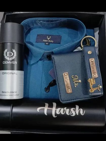 A classic blue and black gift hamper with a personalized temperature bottle, a matching wallet and keychain set, a shirt, and deodorant.