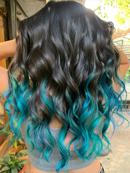 She’s got the ocean tucked in her hair. This turquoise dip dye is for anyone ready to embrace their inner mermaid. This is a bleach color, of course. (No filter)