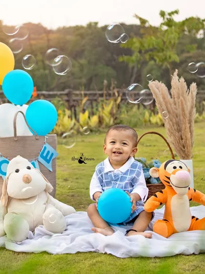 Pure happiness surrounded by bubbles and friends. This shot captures the joyful essence of our outdoor first birthday photography sessions.