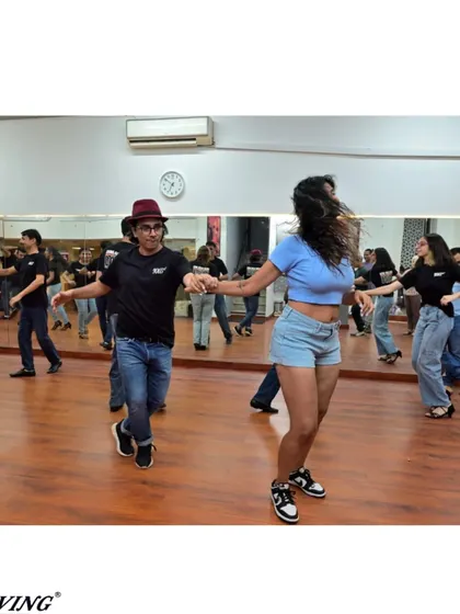 A fun moment of connection during a partner rotation in our Salsa class. We believe dancing is about building community.