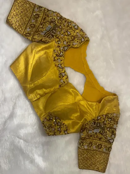 The front view of the gold hand-embroidered blouse, a piece of art crafted with love and heritage in mind.