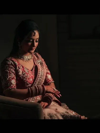 A full-length shot of the bride-to-be, showcasing her beautiful engagement outfit with dramatic, shadowy lighting.