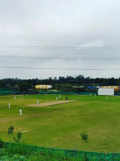A full view of our professional-grade cricket ground during a match. We believe in testing skills in real match situations, not just in the nets.